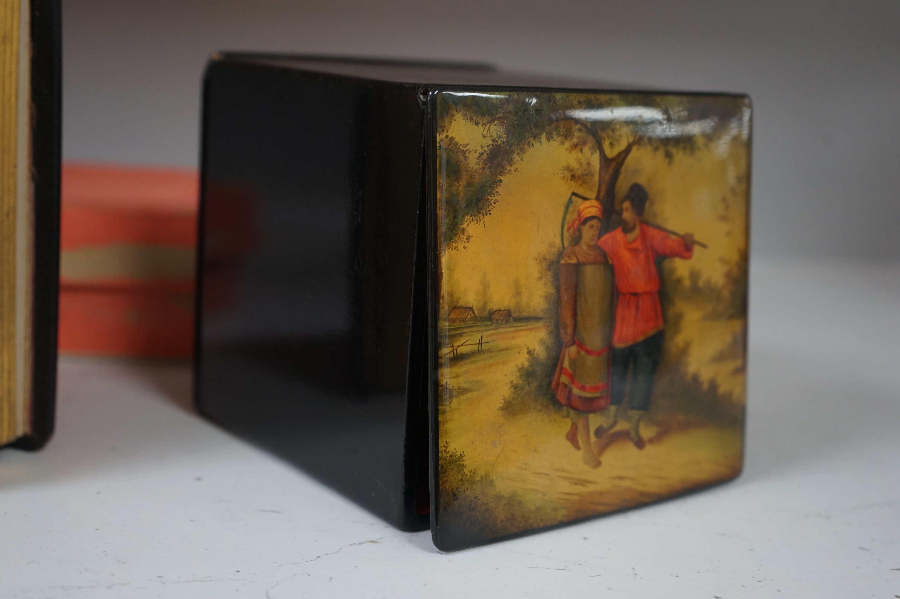 A late 19th / early 20th century Russian lacquer tea caddy and photograph album, largest 16cm high. Condition - fair/good